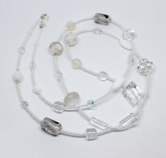 Beautiful and unique white  glass beads necklace. The necklace is made from white and clear glass and crystal beads in different shapes and sizes, making it a truly original piece. The necklace measures approximately 37.5" in length.  Please note that the beads may differ from the one pictured as each necklace is unique. Perfect gift idea or treat for yourself. Wrapped in tissue paper and presented in an organza pouch. White Gemstone Beads Long Necklace, Adjustable Single Strand White Beads, Clear Glass Jewelry With Faceted Beads, White Glass Beaded Necklaces With Polished Beads, White Glass Round Bead Necklaces, White Glass Bead Necklaces, White Czech Glass Necklaces As Gift, White Glass Beaded Necklaces, White Crystal Beaded Necklace