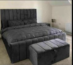 a large bed sitting in the middle of a bedroom