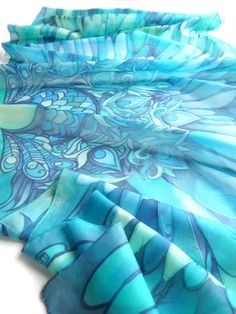 Ocean Blue Wings is a turquoise silk scarves hand painted with bird motif and feathers making a perfect bohemian wedding veil. Think about boho shawl for the bride! Size: 23 by 70 inches (177 by 60 centieters) Silk: pure Habotai Light, semi transparent and a bit glossy. This Wings scarf was designed and hand painted by me as an fashion statement wearable piece of art. The shawl can become a wedding blue veil or a beach pareo or a gorgeous every day scarves. The Blue Wings silk scarf is made to o Blue Angel Wings, Wing Scarf, Blue Veil, Silk Scarfs, Boho Shawl, Geek Design, Hand Painted Fabric, Blue Angel, Blue Wings