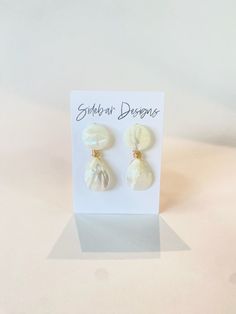 These mother of pearl earrings are handmade. Very elegant while making such a statement. They are great for every day wear, bridal earrings, bridesmaid earrings, and more.  Dimensions: approx. 2" Hypoallergenic gold plated & light weight If you purchase 6 or more, use discount code Bridesmaids15 for 15% off! White Pearl Charm Earrings For Party, Mother Of Pearl Dangle Earrings For Party, Party Mother Of Pearl Dangle Earrings, Pearl Clip-on Earrings For Gifts, Party Pearl Drop Earrings In Mother Of Pearl, White Pearl Clip-on Earrings, Pearl Drop Mother Of Pearl Dangle Earrings, Handmade White Earrings In Mother Of Pearl, Handmade White Mother Of Pearl Earrings