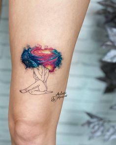 a woman's leg with a tattoo on it that has an image of a heart