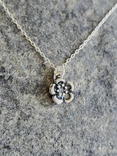 "Tiny sterling silver plum blossom necklace. Our tiny plum blossom necklace is solid sterling silver and has a 3 dimensional flower with an antiqued finish. It hangs from a small but strong sterling silver chain with a sterling spring clasp. The flower measures 8mm across and shown here on a 17\" chain. *If you are unsure of the length you need, or would like to wear this item at different lengths, we now offer an adjustable length option! You can add an adjustable end to your necklace using thi Dainty Sterling Silver Flower Charm Necklace, Sterling Silver Charm Necklace With Flower Pendant, Sterling Silver Flower Charm Necklace With Pendant, Sterling Silver Charm Necklaces With Flower Pendant, Sterling Silver Charm Necklace With Flower Charm, Elegant Silver Flower Charm Necklaces, Elegant Silver Flower Charm Necklace, Dainty Silver Charm Necklace With Flower Pendant, Delicate Flower Pendant Charm Necklace, Nickel Free