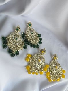 Features: - [HANDCRAFTED] These jhumka earrings are handcrafted with intricate detailing, making each piece unique. - [FOREST GREEN & LIME YELLOW] The vibrant colors of forest green and lime yellow make these earrings stand out. - [ETHNIC INDIAN JEWELRY] These jhumka earrings are a classic piece of ethnic Indian jewelry that can be worn for traditional occasions. Intricate Yellow Earrings For Festivals, Green Dangle Chandbalis For Festivals, Yellow Intricate Design Earrings For Festivals, Green Tikka With Latkans For Festivals, Green Temple Jewelry Tikka With Latkans, Festive Green Chandbalis Dangle, Green Latkans Bridal Earrings For Diwali, Green Chandbali Tikka For Festivals, Green Bridal Earrings With Latkans For Diwali