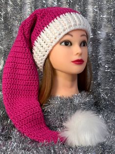 a doll wearing a pink and white knitted hat