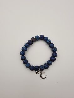 Blue Bead Stretch bracelet with moon and star charm Casual Beaded Bracelets With Star Charm For Gift, Casual Adjustable Beaded Bracelet With Star Charm, Casual Blue Charm Bracelet With Round Beads, Adjustable Bracelets With Star Charm And Round Beads, Adjustable Bracelets With Star Charm, Spiritual Blue Bracelets With Letter Beads, Blue Beaded Bracelets With Star Charm For Gift, Blue Charm Bracelet With Letter And Round Beads, Blue Bracelet With Star Charm As Gift