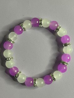 Cute plain purple and white braclet. Purple And White Bracelet, White Stretch Bracelet With 8mm Beads, Pink And Purple Bracelet, White Beaded Round Bracelets, White Crystal Bracelet With Colorful Round Beads, White Beaded Round Wristband, Purple Stretch Bracelet With Colorful Beads, Purple Bracelet With Colorful Beads, Purple Bracelets With Colorful Round Beads