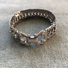 "This bracelet has some weight to it. The curb chain at the center is flanked by snake chains which are soldered to it so the piece moves as a sinuous whole. The clasp belies the more modernist look of the chain, with it's lyre shaped finials holding the fold over closure. The piece measure 7 3/4\" long by 3/4\" wide.  I'm happy to ship internationally but costs have risen so dramatically I can no longer ship worldwide for $12. If you are outside of the US and want to make a purchase. Let me kno Metal Box Chain Link Bracelet, Metal Box Chain Link Bracelets, Metal Link Bracelets With Box Chain, Adjustable Curb Chain Jewelry For Formal Occasions, Formal Adjustable Curb Chain Jewelry, Sterling Silver Jubilee Link Bracelet, Metal Cuban Link Bracelet With Curb Chain, Cuban Link Bracelet With Curb Chain In Metal, Formal Sterling Silver Link Bracelet With Curb Chain