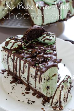 a piece of ice cream cake on a plate with oreo cookies and chocolate drizzle