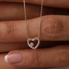 This 14K Gold Open Heart Necklace with CZ Pave is a beautiful and versatile piece, perfect for any occasion. Its minimalist design and sparkling cubic zirconia accents make it suitable for both daily wear and special events. Ideal as a birthday gift or a present for a bride, this necklace symbolizes love and affection. Pair it with matching jewelry for a coordinated look. Its quality craftsmanship and timeless design ensure it will be cherished for years to come. Product Features: * Made to Order: Crafted specifically to your preferences. * Gold KT: 14K Solid Gold (not filled, not gold vermeil, not plated) * Gold Color Options: Choose from Yellow, Rose, or White Gold, tailoring the necklace to your preferred style. * Gemstone: Adorned with a dazzling Cubic Zirconia, adding a touch of brill Diamond Heart Necklace For Wedding On Valentine's Day, Heart Cut Heart Charm Necklace For Wedding, Heart Cut Necklace With Heart Charm For Wedding, Wedding Heart Necklace With Diamond Accents For Valentine's Day, Valentine's Day Wedding Heart Necklace With Diamond Accents, Valentine's Day Wedding Diamond Heart Necklace, Heart Necklace With Diamond Accents For Wedding, Wedding Necklace With Heart Charm And Cubic Zirconia, Wedding Cubic Zirconia Necklace With Heart Charm