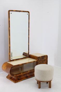 an antique vanity with stool and mirror on display