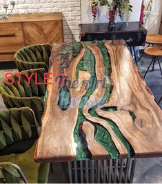 a table made out of wood with green and brown designs on it in a room