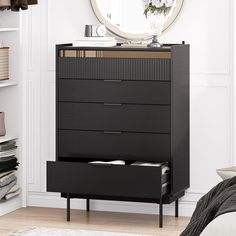 a black dresser with drawers and a mirror above it in a white room next to a bed