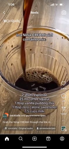 a cup filled with liquid sitting on top of a wooden table