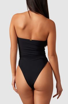 This one-piece is the perfect combination of classy and sexy. Boning and silicone elastic keep this strapless one-piece up and in place so you feel comfortable and secure. Ultra soft material, strapless, double lined Brazilian bottom coverage High cut at hips elongate the legs Elastic in waistband cinches in waist Solid Strapless Swimwear With Smoothing Details, Solid Strapless Smoothing Swimwear, Strapless Smoothing Swimwear, Elegant Strapless Stretch Swimwear, Elegant Solid Micro-elastic Swimwear, Elegant Strapless Smoothing Bodysuit, Strapless Nylon Swimwear, Chic Strapless Seamless Swimwear, Elegant Stretch Bandeau Bodysuit