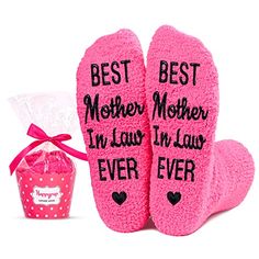 two pink socks with sayings on them next to a gift bag