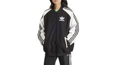 The original adidas Collegiate Jacket goes oversize for a stylish statement. This loose-fitting design creates a casual, comfortable silhouette perfect for layering over tees or wearing on its own. Ribbed cuffs add sporty detail inspired by athletic styles of the past. The look pays tribute to the legacy of adidas, celebrating their rich heritage in sport and style. Fit & Design: Oversized fit Button front closure with ribbed collar Side pockets Ribbed cuffs and hem. | Adidas Originals Women's Adicolor Collegiate Jacket Black/White (XL) | Dick's Sporting Goods Adidas Originals Women, Athletic Fashion, Oversized Fits, Adidas Originals, Layering, Loose Fitting, Jackets For Women, Black White, Adidas