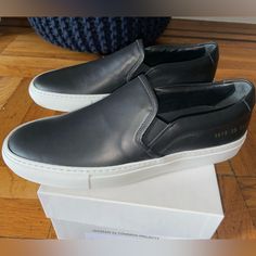 Brand New/Never Worn Modern Black Slip-ons With Rubber Sole, Modern Black Slip-ons With Contrast Sole, Classic Black Slip-ons With Stitched Sole, Black Sneakers With Vulcanized Sole In Calf Leather, Black Calf Leather Sneakers With Vulcanized Sole, Classic Black Calf Leather Sneakers, Modern Leather Slip-on Sneakers With Vibram Sole, Classic Slip-on Sneakers With Contrast Sole, Sporty Leather Slip-ons With Vulcanized Sole