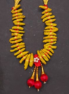 a necklace with yellow and red beads