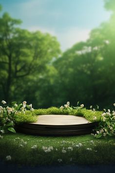 an empty wooden platform in the middle of some grass and flowers with trees in the background