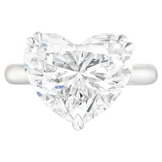 This stunning solitaire engagement ring features an 8.40 carat heart shaped diamond as its centerpiece, exuding romance and elegance. Crafted in platinum, the setting offers durability and complements the stone’s radiant beauty. Certified by GIA, the diamond boasts an E color grade, ensuring a nearly colorless brilliance that enhances its captivating sparkle. With a VVS2 clarity grade, it reveals exceptional purity, with inclusions visible only under magnification. The excellent polish ensures a Flawless Diamond Ring, Single Diamond Ring, Fancy Yellow Diamond Ring, Heart Shape Ring, Heart Shaped Diamond Ring, Pear Cut Diamond Ring, Brilliant Cut Diamond Ring, Edwardian Engagement Ring, Emerald Cut Diamond Engagement