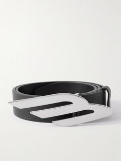 Balenciaga's textured-leather belt is centred with a slanted silver-tone logo, giving it the cool, futuristic look the brand is known for. Tuck in your shirt to show it off. Modern Black Belts With Silver-tone Logo Plaque, Modern Black Belts With Silver-tone Logo, Modern Black Belt With Silver-tone Logo Plaque, Modern Business Belt Buckles With Metal Logo, Elegant Black Belt With Silver-tone Logo, Business Leather Belt Buckles With Metal Logo, Leather Belt Buckles With Metal Logo For Business, Silver Leather Belt Buckle With Logo Plaque, Classic Leather Belt With Silver-tone Logo Plaque