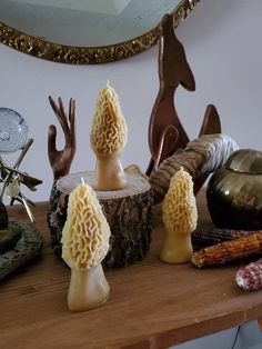 several carved mushrooms are sitting on a table next to other items and decorating them