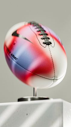 a close up of a football on top of a white box with shadows in the background