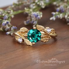 Nature Inspired Leaf Emerald Ring Art Deco Emerald Pearl Gold Ring Vintage Leaf Engagement Ring Birthstone Anniversary Promise Gift For Her ※Setting in Akoya pearl: https://www.etsy.com/listing/1342174889/natural-pearl-diamondmoissanite-ring ※Setting in Moonstone: https://www.etsy.com/listing/1251219218/vintage-moonstone-engagement-ring-leaf ▶ Ring Details: ※Metal: 14K or 18K Solid Gold (Rose, White, or Yellow), Silver ▶Engagement Ring： ※Center Stone: Lab Created Emerald ※Shape&Quality: 6mm, Rou Gold Emerald Ring With Nature-inspired Design, Gold Nature-inspired Emerald Ring As A Gift, Nature-inspired Gold Emerald Ring As A Gift, Nature-inspired Gold Emerald Ring As Gift, Nature-inspired Gold Emerald Ring For Gift, Nature-inspired Gold Emerald Ring Gift, Gold Flower Ring With Emerald, Gold Flower Ring With May Birthstone, Nature-inspired Emerald Ring For May Birthstone Gift