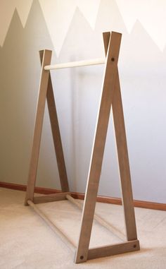 a pair of wooden stands in front of a wall with mountains painted on the walls