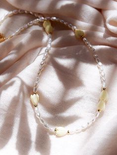 Inspired by traditional Hawaiian leis gifted as tokens of hospitality, this handmade gold and pearl necklace features a glistening collection of pearls, gold beads and pikake flower blossoms.✦ DETAILS ✦✧ Name: Mele (MEH-leh) - Song.✧ Adjustable Length from: 16"-18".✧ White Freshwater Pearls.✧ Carved Resin Pikake Beads✧ 14kt Gold Filled Components, Extender, and Clasp.✧ All Ke Aloha Jewelry pieces come packaged thoughtfully, beautifully, and ready for gift giving. Handmade Yellow Pearl Necklaces, Yellow Pearl Beaded Necklaces As Gift, Yellow Pearl Necklaces With Round Beads, Yellow Beaded Pearl Necklace, Handmade Yellow Pearl Necklace For Gift, Traditional Cream Necklace As A Gift, Traditional Cream Necklace For Gift, Yellow Beaded Pearl Necklace Gift, Yellow Beaded Pearl Necklace As Gift