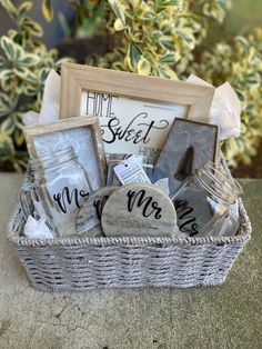 a wicker basket filled with personalized items and a sign that says home sweet