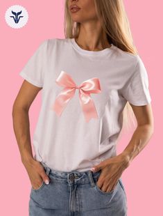 Cute Pink T-shirt With Bow, Cotton Crew Neck Top With Bow Print, Cute Cotton T-shirt With Pink Bow, Short Sleeve Cotton Top With Pink Bow, Pink Cotton Shirt As Gift, Cotton Short Sleeve Top With Pink Bow, Pink Cotton Shirt As A Gift, Cotton Top With Pink Bow And Short Sleeves, White Cotton Top With Pink Bow