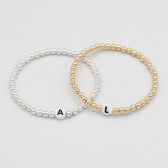 One of our classics from the beaded bliss collection with a twist. The 'name it' collection allows you to customize your bracelet with your desired initial! Customers love to wear the initials of their kids or wear their personal monogram by stacking three separate initial bracelets. The perfect piece of jewelry to create a thoughtful gift that can be worn every day. Just add your desired initial in the space above. This style is created with one of our "stretchy" cords for easy wear and effortl Initial Bracelets, Chains Necklaces, Initial Bracelet, Personalized Monogram, Pendant Bracelet, Easy Wear, Charm Necklace, Thoughtful Gifts, Gold Filled