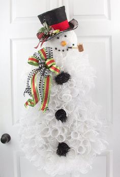 a snowman wreath is shown on the front door with instructions for how to make it