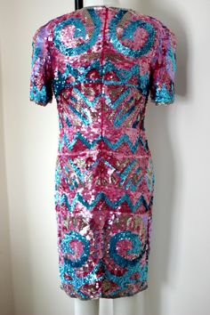 "So fun and so funky!! Vintage 80 sequin/bead hot pink, blue, silver dress! Sooo shiny and sparkly. You will definitely be the center of attention in this unique piece! 100% silk Zips in the back and is in Very good condition! I do not see any sequin loss. Hot pink silk lining Stunning geometric design with beautiful details Measuring: 38\" long Bust: 34\" Waist: 30\" Hip 36\" Pet free/ smoke free Enjoy!" Disco Style Embellished Sequin Dress For Party Season, Disco Embellished Sequin Dress For Party Season, Party Season Disco Embellished Sequin Dress, Disco-style Embellished Sequin Dress For Party Season, Festive Pink Dress With Contrast Sequin, Festive Pink Dresses With Contrast Sequin, Glamorous Sequin Fancy Dress, Glamorous Sequined Dresses For Fancy Dress, Party Season Pink Dress With Contrast Sequin