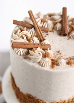 a white cake with cinnamon sticks on top