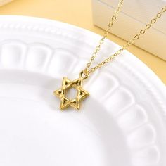 This 18K Gold Plated Star of David Necklace offers a timeless blend of tradition and elegance. Featuring a beautifully crafted Star of David pendant on a dainty gold chain, this necklace is perfect for both daily wear and special occasions. The adjustable chain ensures a comfortable fit, making it a versatile and meaningful addition to any jewelry collection. Features: Material: 18K gold-plated stainless steel Pendant Design: Star of David Chain Length: 16 inches + 2 inches extension (40 cm + 5 Dainty Gold Chain, Star Of David Necklace, Star Of David Pendant, Stainless Steel Pendant, Star Of David, Pendant Design, Earring Necklace, Chain Lengths, Chain Length