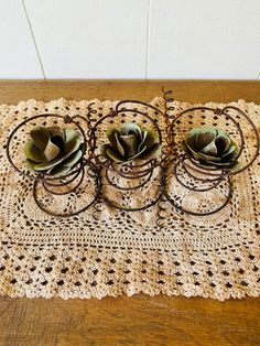 three succulents sitting on top of a doily