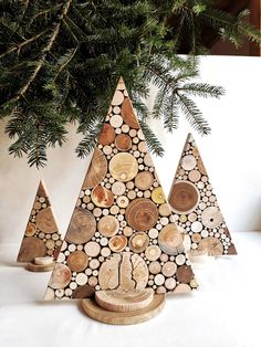 three wooden christmas trees sitting next to each other