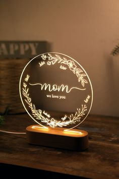 a personalized lamp with the word mom on it sitting on top of a wooden table