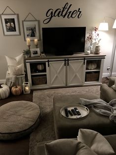 a living room filled with furniture and a flat screen tv on top of a wooden entertainment center