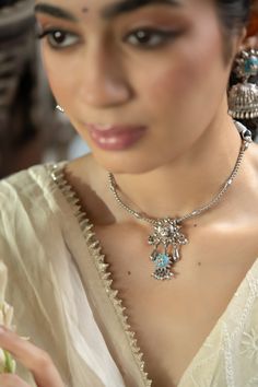 Inspired by the Firoza stone, a symbol of victory, success, and good fortune, the handcrafted Firoza Necklace exudes timeless beauty. Featuring the vibrant Firoza stone as its centerpiece, this necklace is adorned with an intricate Mughal art-inspired motif that brings together tradition and modernity. Designed with an adjustable thread closure for maximum comfort and versatility, it’s perfect for any festive occasion or everyday elegance. Wear the Firoza Necklace to embrace its charm, prosperit Silver Kundan Necklace With Stone Work For Gift, Traditional Round Pendant Necklaces For Diwali, Traditional Silver Temple Necklace With Stone Work, Fusion Style Gemstone Temple Necklace, Spiritual Jewelry With Intricate Design For Diwali, Bohemian Tilla Necklaces As Gift, Festive Jewelry With Intricate Design, Spiritual Temple Necklace With Gemstones For Festive Occasions, Fusion Style Handmade Kundan Necklace For Rituals