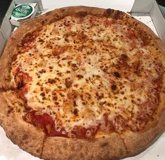 a pizza sitting on top of a white box