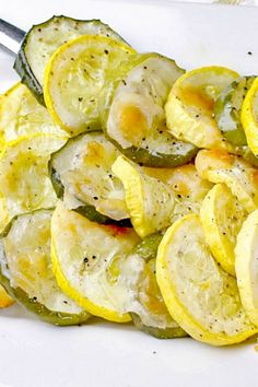 sliced up lemons and zucchini on a white plate