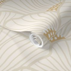 a white and gold wallpaper with an intricate design on the bottom half of it