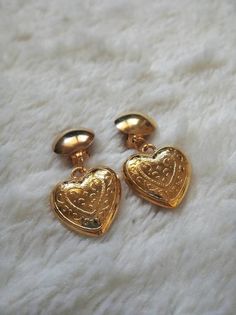 Deadstock vintage gold heart earrings 90s gold heart drop earrings heart clip on earrings. by MaletaVintageClothes Gold Heart Shaped Clip-on Earrings For Wedding, Heart-shaped Clip-on Wedding Earrings, Wedding Heart-shaped Clip-on Earrings, Gold Clip-on Earrings For Valentine's Day Gift, Vintage Heart Charm Earrings For Valentine's Day, Gold Heart-shaped Clip-on Earrings For Anniversary, Vintage Heart Charm Drop Earrings, Vintage Drop Earrings For Valentine's Day, Vintage Heart Earrings For Valentine's Day