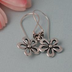 Cute silver plated flower earrings that hang on high quality Sterling silver ear wires. One of my favorite flowers. Comes wrapped ready for gift giving. Sterling Silver Flower Earrings As A Gift For Her, Sterling Silver Dangle Flower Earrings For Gifts, Sterling Silver Flower Earrings For Mother's Day, Hypoallergenic Sterling Silver Flower Earrings For Her, Sterling Silver Flower Charm Earrings As Gift, Silver Flower Earrings As Gift For Her, Sterling Silver Flower Pendant Earrings As Gift, Mother's Day Sterling Silver Flower Earrings, Dangle Flower Earrings With Ear Wire For Mother's Day