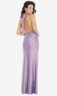 the back of a woman wearing a long purple dress with a bow at the neck