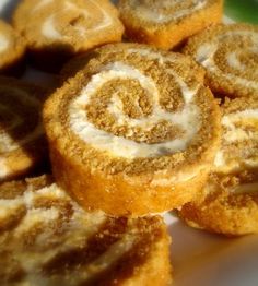 several cinnamon rolls on a plate with icing