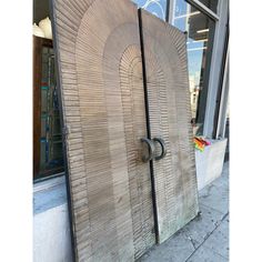 the door is made out of wood and has a circular design on it's side